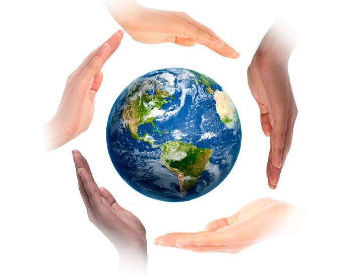 Hands of different races in a protective attitude with the planet Earth