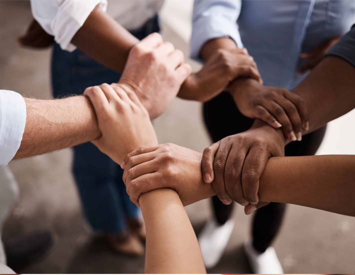 Hands of different races in a collaborative attitude