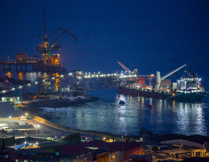 Freighter ship unloading at night